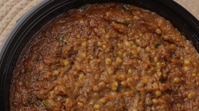 Freshly Cooked Healthy Millet Khichdi Served Hot in a Black Bowl, Close-Up Food Shot.