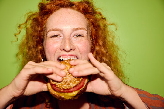 Woman bites a big burger
