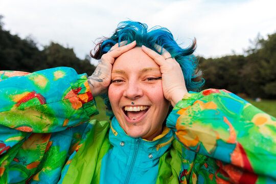 Woman laughing with hands on head