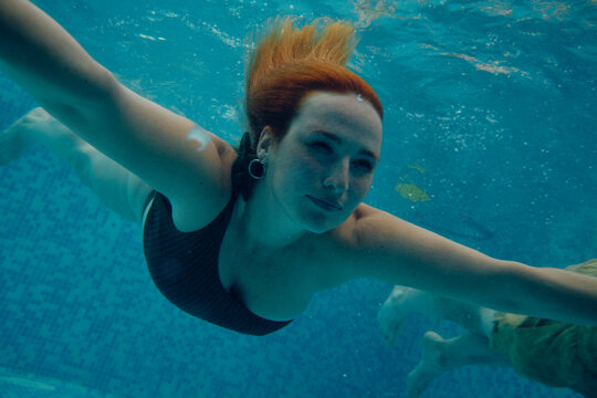 Woman Dives in a Pool