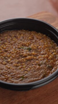Freshly Cooked Healthy Millet Khichdi Served Hot in a Black Bowl, Close-Up Food Shot.