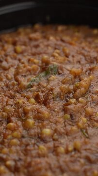 Freshly Cooked Healthy Millet Khichdi Served Hot in a Black Bowl, Close-Up Food Shot.