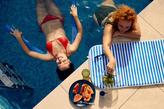 Two women enjoy their leisure time in the pool