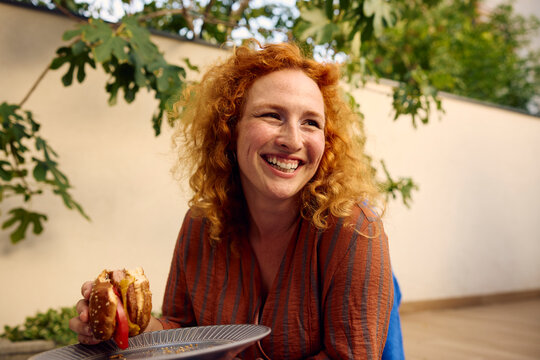 Woman Enjoys a Homemade Burger