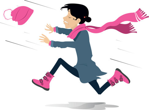Young woman chasing a hat gone with the strong wind