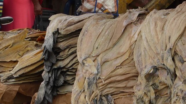 Close up view of stacks of traditional salted dried fish displayed at a local market