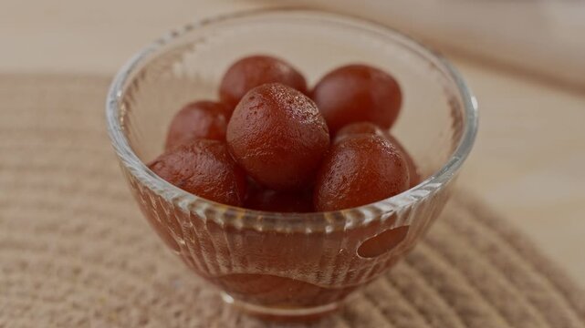Soft Bite-Sized Mini Gulab Jamun Soaked in Warm Sugar Syrup, Traditional Indian Dessert Close-Up Shot
