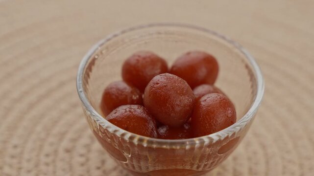 Soft Bite-Sized Mini Gulab Jamun Soaked in Warm Sugar Syrup, Traditional Indian Dessert Close-Up Shot