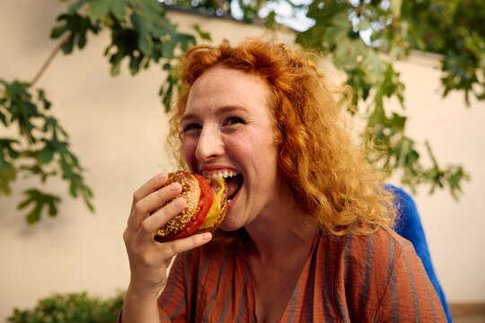 Woman Enjoys a Large Burger