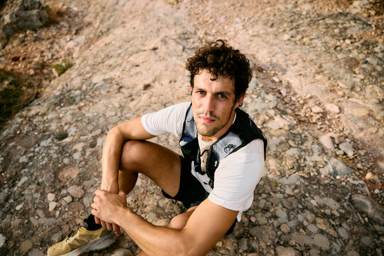 Trail Runner Resting on Rocky Path