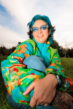 Portrait of smiling bold woman in colorful jacket
