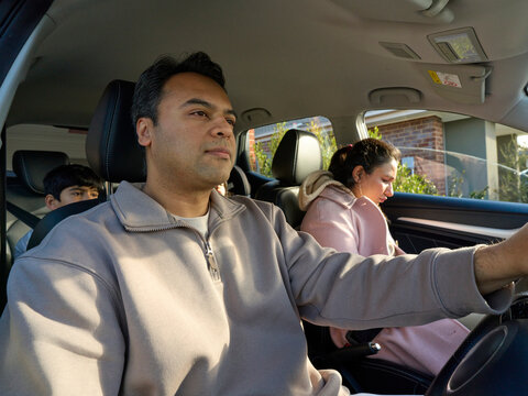 Family Members in a Car Preparing for a Trip in the Morning