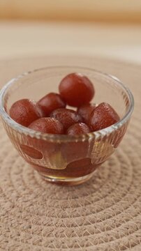 Soft Bite-Sized Mini Gulab Jamun Soaked in Warm Sugar Syrup, Traditional Indian Dessert Close-Up Shot