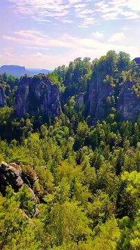 View over monumental Bastei sandstone pillars and ancient bridge near Kurort Rathen village in the national park Saxon Switzerland by Dresden, Saxony, Germany.