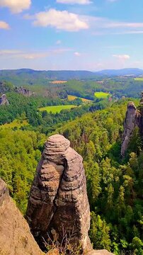 View over monumental Bastei sandstone pillars and ancient bridge near Kurort Rathen village in the national park Saxon Switzerland by Dresden, Saxony, Germany.