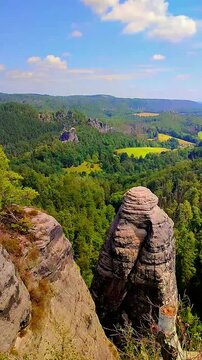 View over monumental Bastei sandstone pillars and ancient bridge near Kurort Rathen village in the national park Saxon Switzerland by Dresden, Saxony, Germany.