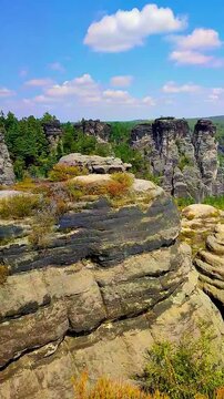 View over monumental Bastei sandstone pillars and ancient bridge near Kurort Rathen village in the national park Saxon Switzerland by Dresden, Saxony, Germany.
