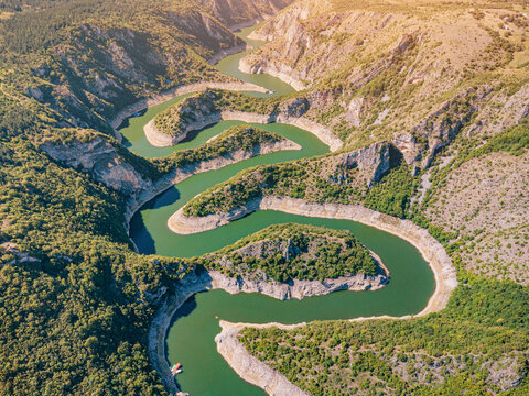 Winding canyon with serpentine green river bends photographed from above in Serbia. Travel destination concept.