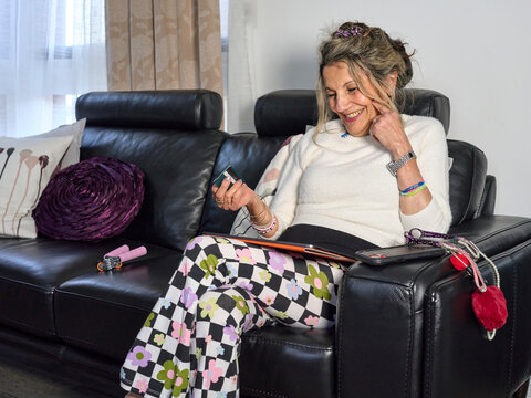 Happy Senior Enjoying Time Purchasing Gifts Online Using an iPad