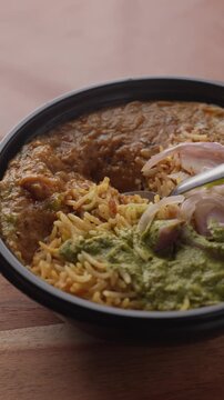 Aromatic Spiced Masala Rice Served with Rich Indian Curry and Fresh Sliced Onion Topping in a Bowl, Close-Up Food Shot.