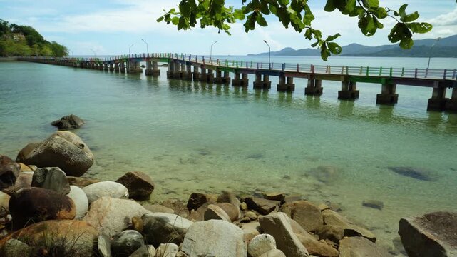 Long Wooden Pier Over Clear Tropical Sea