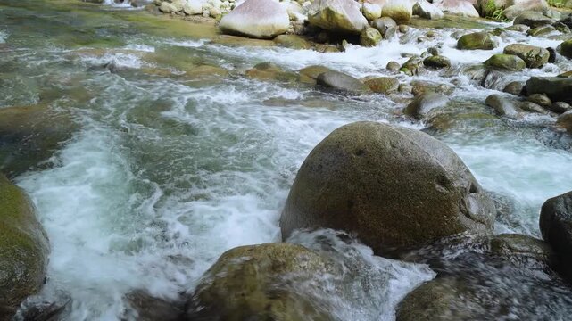 Fast Flowing River Around Massive Granite Rock