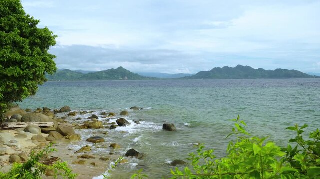 Rocky Tropical Coast With Distant Mountains