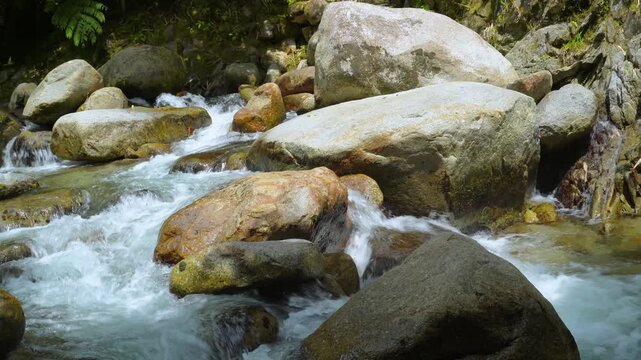 Fast River Current Around Large Granite Rocks