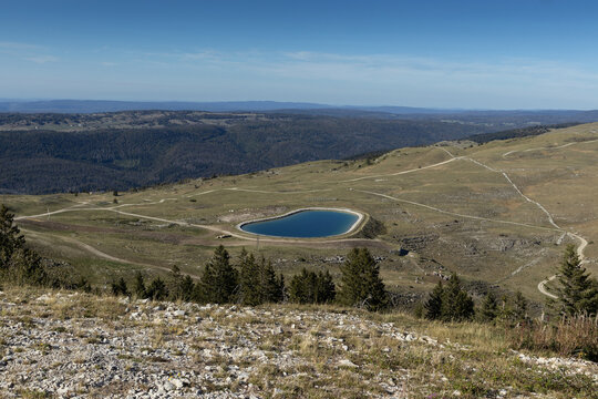 Aerial view of water reservoir and the top of the Col de Crozet in the Jura mountains, near Lelex, France in the summer. It is primarily used for snowmaking on the local ski slopes in winter.