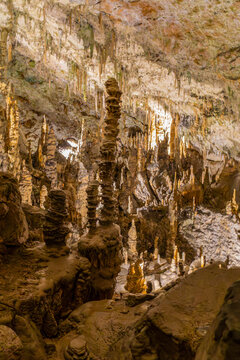 Towering stalagmites and underground chamber in Postojna Cave, Slovenia