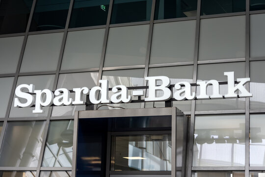 Berlin, Germany - 16 August 2026. Sparda-Bank sign mounted above a glass entrance at a modern commercial building. Banking, finance, corporate, commerce, services, customer, trust, Germany.