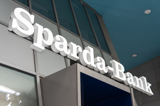 Berlin, Germany - 16 August 2026. Sparda-Bank sign mounted above a glass entrance at a modern commercial building. Banking, finance, corporate, commerce, services, customer, trust, Germany.