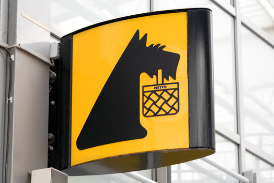 Berlin, Germany - 16 August 2026. Netto supermarket storefront with bold yellow sign on a modern shopping center. Retail, shopping, commerce, urban architecture, consumer culture.