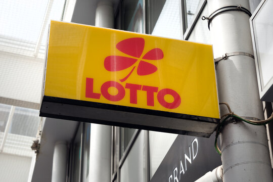 Berlin, Germany - 16 August 2026. Lotto sign with clover logo advertises lottery tickets outside a city storefront. Themes include luck, chance, gambling, betting, retail, urban commerce, fortune.