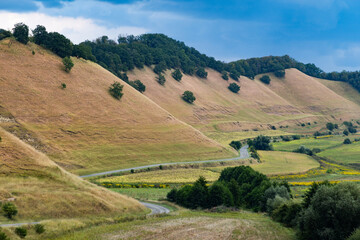 Naklejka premium valley with rolling hills in summer