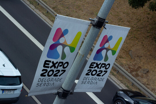 Belgrade, Serbia - September 6, 2026: Street city photo. Top angle view. Vertical promotional banners with EXPO 2027 logo on pole along road, roadway. Prepares for international specialized exhibition