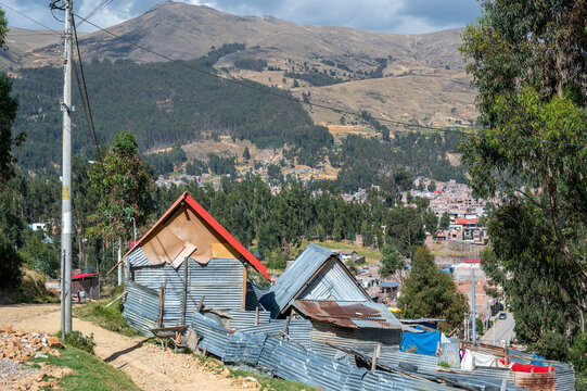 Cochas, Peru - : Corrugated metal homes stand along a steep hillside road in the Andean highlands near Huancayo. The scene on the route between Cochas and Cruz de la Paz.