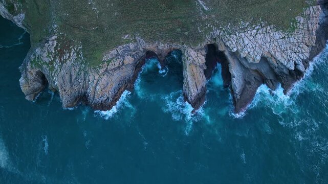 Aerial drone view of the sea cliffs near the village of Islares in the municipality of Castro Urdiales. Cantabrian Sea. Cantabria. Spain. Europe