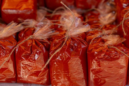 ground red paprika powder packaged in transparent plastic bags for sale at street market stall during wine festival