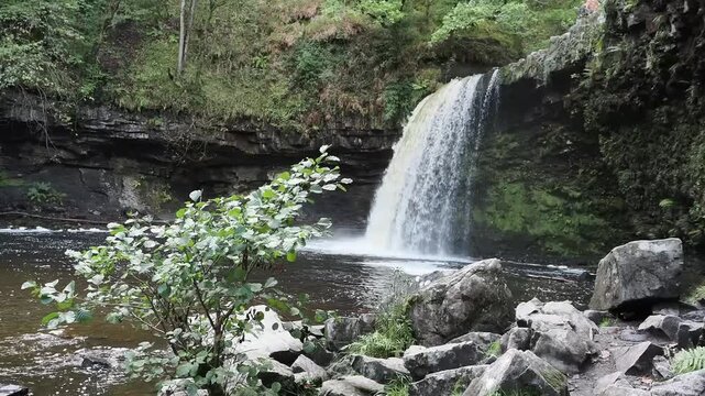 Lady Falls waterfall (Sgwd Gwladys) along the Elidir Trail in South Wales UK, featuring cascading water into a natural pool, waterfalls stock video footage clip 