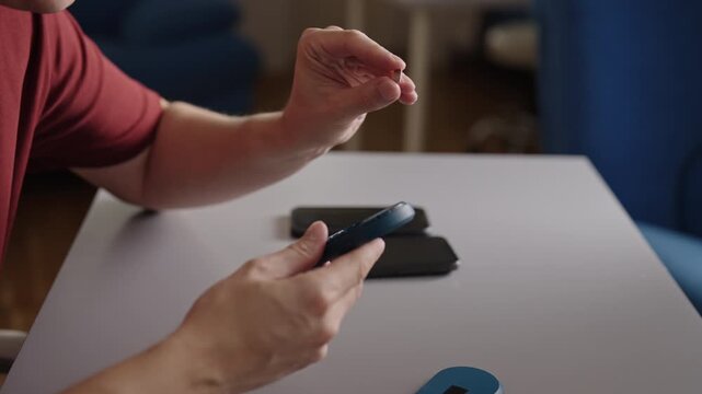 Male hands inserting nano SIM card into portable Wi Fi router, preparing pocket sized device for establishing mobile internet hotspot for wireless access, close-up, slow motion.
