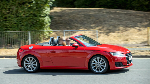 Milton Keynes,UK - Aug 2nd 2026: 2015 red Audi tt convertible car driving on a British road