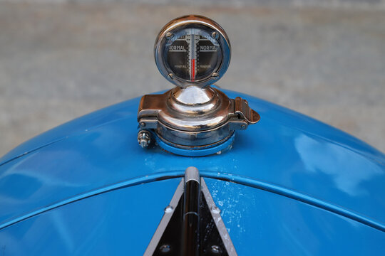 Radiator cap with temperature gauge on a vintage car, 1934