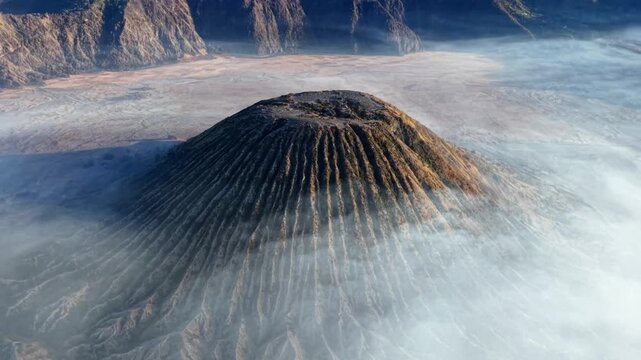 Aerial view of Mount volcano cone surrounded by morning mist in caldera