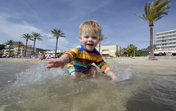 Toddler playing at the beach, Port de S&oacute;ller, Majorca, Balearic Islands, Spain