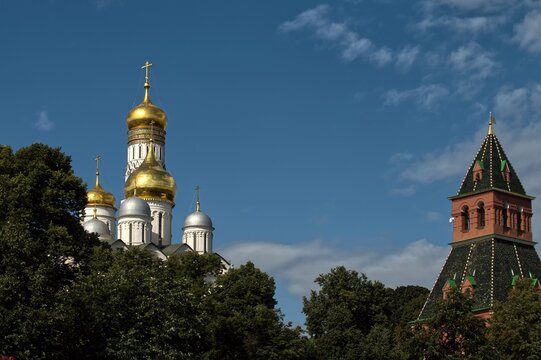 Golden domes of orthodox church inside the Kremlin in Moscow under blue sky