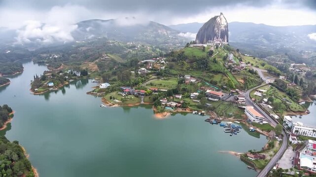 Guatap&eacute; with Piedra del Pe&ntilde;ol Rising above the Reservoir and Mountain Landscape in Antioquia, Colombia. Time Lapse. Establishing Shot. Aerial View.