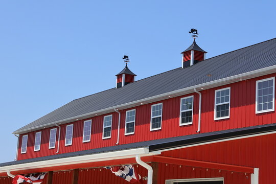 A bright red barn on a warm summer day.