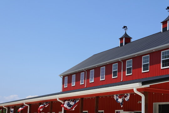 A bright red barn on a warm summer day.