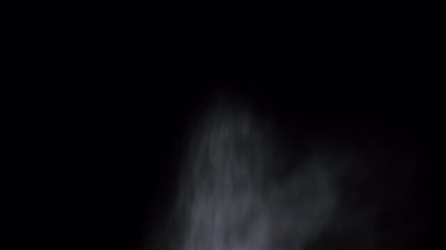 Subtle wisps of white smoke rising against a dark black background.
